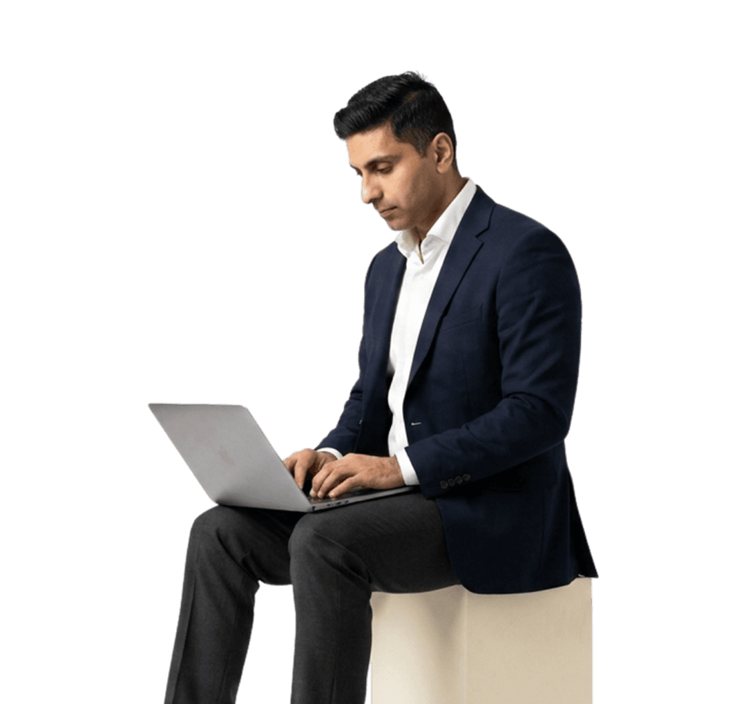 Jamil Rehman, Chairman of the Board, working at a laptop